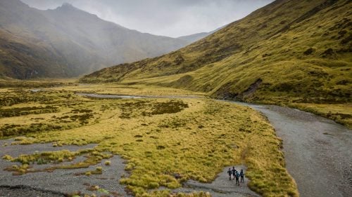 A team navigating its way along the valley toward the Albert Burn Saddle.