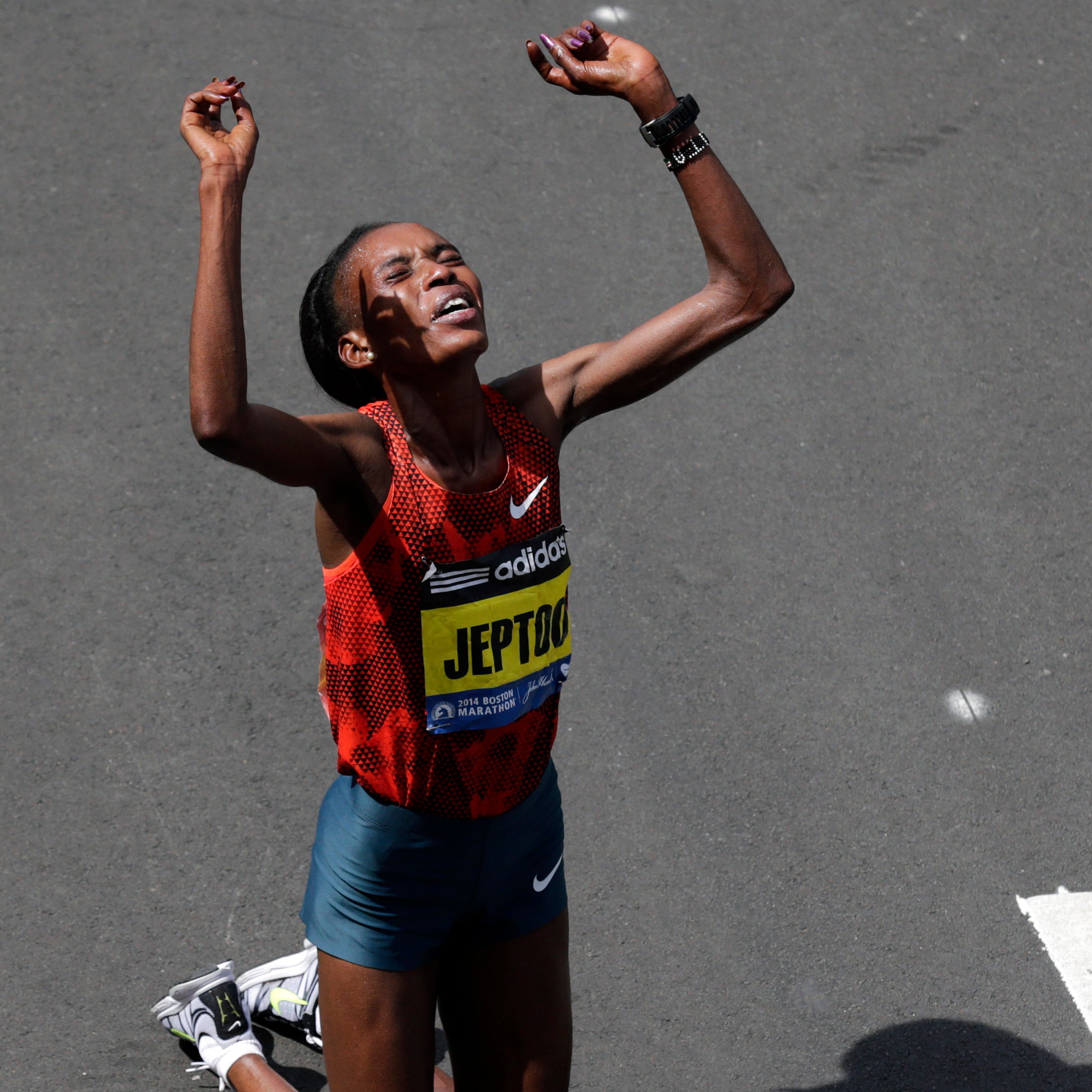 Rita Jeptoo, of Kenya, celebrates her win in the women's division of the 118th Boston Marathon Monday, April 21, 2014 in Boston. (AP Photo/Charles Krupa)