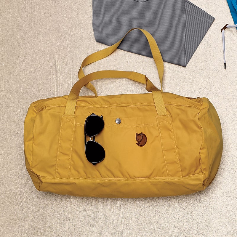 Cut from Fjällräven’s cotton-poly G-1000 fabric and treated with paraffin and beeswax for durability and water-resistance, the No.5 ($100) allows your sweaty layers to vent but still fends off light rain and dries quickly. Two outer pockets (one zip, one snap) keep essentials in easy reach. fjallraven.us