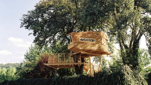 The structure was a gift from a wife to her husband and sits nestled in a pear tree above orchards and vineyards. Windows and skylights ensure occupants maintain a connection with the outdoors, while a spacious terrace allows the couple to admire their property.