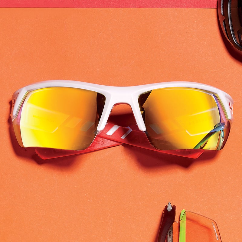 Best For: Jocks on a budget.
The Test: Lightweight temples hug the head with tenderness, as if the Igniter ($105) likes you. Sticky rubber at the ears and nose strengthen the bond, so you can bang around and still be one with your glasses. Others see orange mirroring while you get a sharp, high-contrast view through warm polarized polycarbonate. The half-frame design minimizes clutter, while lens coatings repel sunscreen and anything oily.
The Verdict: Go fast, save money. underarmour.com
Style: 5
Versatility: 4