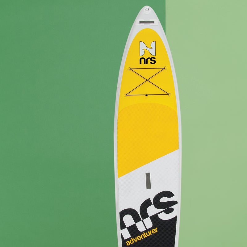 Best For: Taking overseas.
The Test: Inflatable SUPs have gone from floppy, flaccid messes to bona fide alternatives to hard boards for travelers or the storage challenged. Like other elite members of the new school, the Adventurer ($1,295) can be inflated to a rock-solid 15 psi, gaining remarkable rigidity and a surprising amount of glide. “As smooth as a classic longboard,” said one tester. Unlike its peers, the 30.5-inch-wide, six-inch-thick Adventurer is designed for serious journeys, with stainless- steel D-rings that make it easy to rig up the nose for hauling gear on an overnighter. Bonus: interchangeable fins let you customize the configuration to match water conditions.
The Verdict: Impressively stout and mission-ready. 12'6"; nrs.com
Stability: 4
Glide: 3