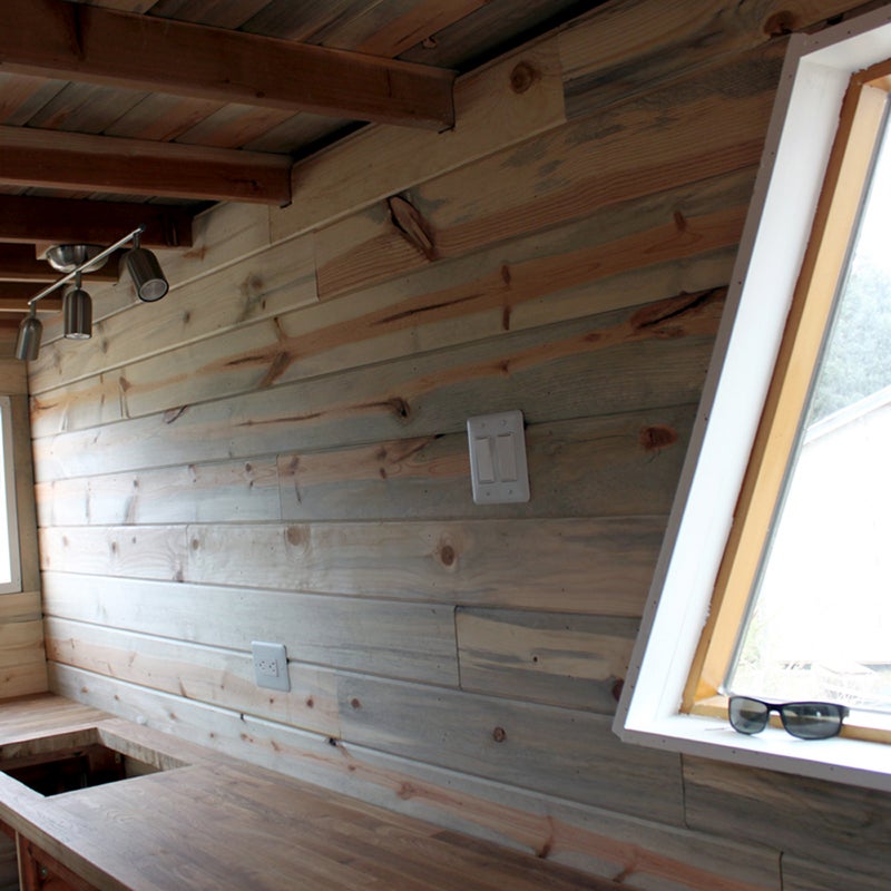 Tiny-house owners often look to sailboats for design inspiration, particularly when it comes to kitchens. “Sailboat appliances are built to last in harsh environments, and they’re very economical in terms of space,” says Smith. The pair opted for an alcohol-burning stove. The only downside: At high altitudes, it produces a lot of carbon monoxide, so they have to vent diligently.
What type of kitchen you build depends on how often—and what meals—you’ll cook. In the spirit of radical minimalism, you can get away with just a few pots, pans, plates, bowls, and utensils. Pro tip: Hang them up or store them in open shelving to make the kitchen appear more spacious.