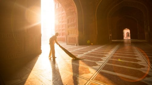 Dust sparkled in the early morning rays as the sun warmed our bare feet on the cool floors of the Taj Mahal mosque.