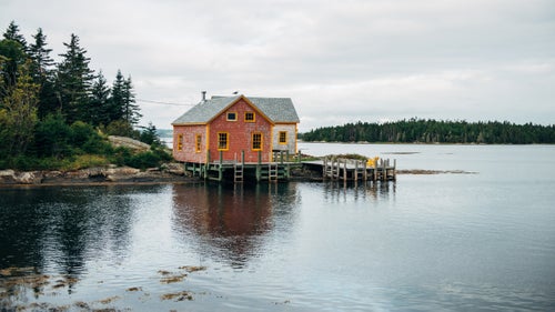 Filled with excitement one summer, we drove from Rhode Island to Nova Scotia in a day. After searching for a nonintrusive place to park and set up camp, we ended up discovering Bell Island. An elderly fisherman who was taking a walk in the neighborhood gave us permission to sleep in our truck at the end of the road. In the morning, we decided to walk around the area and took this picture of our neighbor’s house.