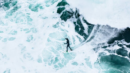 I'm always looking for new ways to photograph surfing, and lately that's meant hanging out of a helicopter looking straight down on the subject. This is Peter Devries bottom-turning on a wave near Tofino.