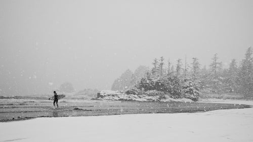 It rarely snows in Tofino, but when it does it's usually thick and heavy. Here, my friend Raph Bruhwiler walks out to go surfing at one of our local beaches. Walking to the beach and shooting this day was much colder than actually being in the water, which stays at around 50 degrees even in the winter.