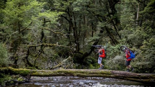 Riders Traharn Chidly and Mike Hopkins make one of the river crossings on the Te Iringa trail.