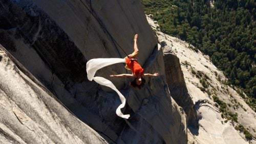 Artistic director Amelia Rudolph leaps into midair, trailing a ribbon of white silk. For Rudolph, Bandaloop’s Yosemite performance, dubbed “Crossing” and largely funded by the National Endowment for the Arts, is an opportunity to explore the idea of dance staged as a journey.