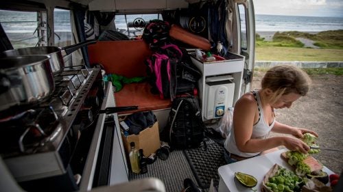 Brown cooking in our camper. The produce, purchased from roadside stalls, was all grown on land we passed through. Life on the road was humbling. Showers were limited at our chosen campsites, and we powered our electrics with Goal Zero solar chargers and happily lived off the grid.