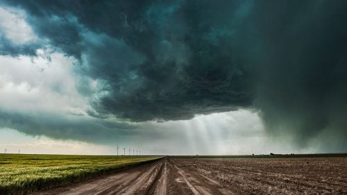 Dirt roads and storm chasing don’t mix—the last thing you want is to be stuck in mud as a hail-filled supercell approaches. The crepuscular rays of light give scale to this otherwise ominous supercell that was bearing down on us.