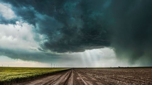 Dirt roads and storm chasing don’t mix—the last thing you want is to be stuck in mud as a hail-filled supercell approaches. The crepuscular rays of light give scale to this otherwise ominous supercell that was bearing down on us.