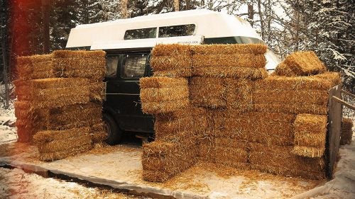 Stacking the hay bales like building blocks, Eastbound spent a day covering the van.