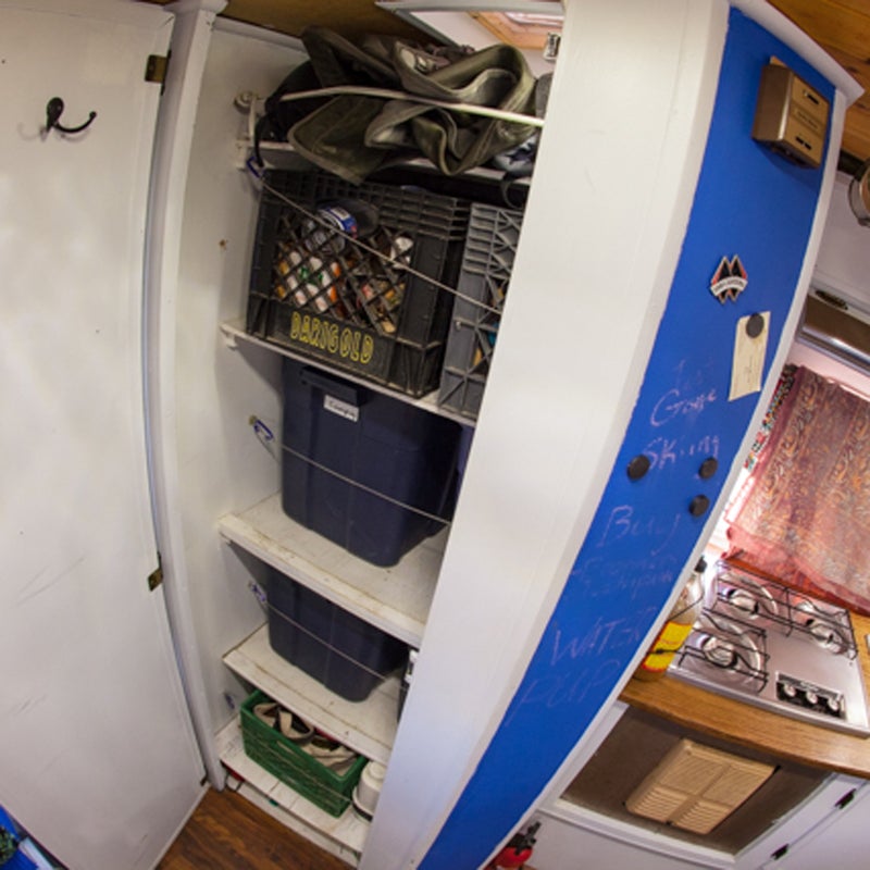 In a 100-square-foot tiny home, you need efficient storage solutions. I turned the bathroom into a closet, built a dresser at the end of the bed for clothes, increased the shelving over the dining room table, and added even more storage under the bed.