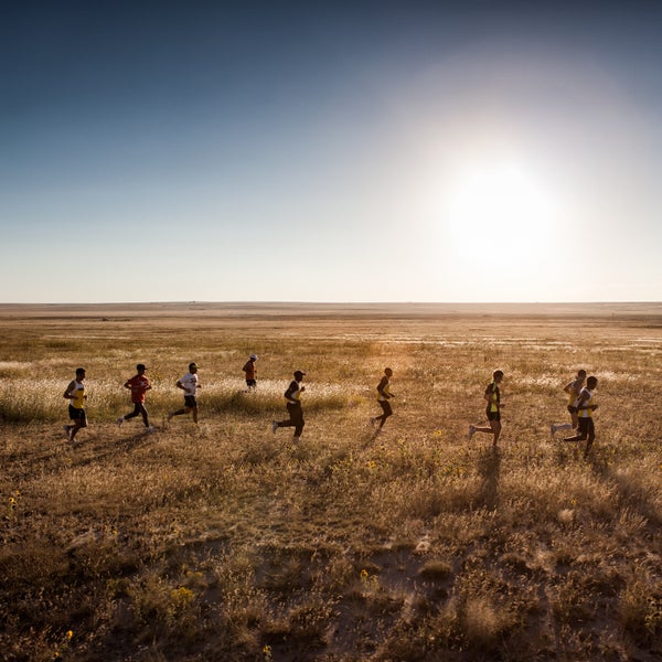 Runners pursue a pronghorn antelope over the plains of Northern New Mexico in August 2014.