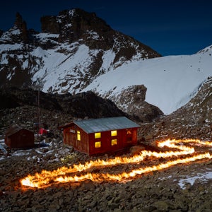 With petroleum as his paint, English photographer Simon Norfolk took to Africa’s second highest peak, Mount Kenya, to outline the mountains’ vanishing Lewis Glacier. Using old maps and meticulous GPS plotting, the fire lines represent an old section of the glacier, often a large distance from the glacier’s current front. Norfolk’s work, completed in 2014, is marked by grief but he hopes it also serves as a call to action. In his words, to think that “in ten or twelve years this magnificent glacier that has endured for millennia will exist only in photographs, is unbearable.”Photo: Norfolk was born in 1963, the year of the glacier’s position depicted by this fire line. At that time only the small hut on the left existed. The larger structure with the lights on, called the Austrian Hut, was built in 1972 and served as Norfolk’s residence during this project in 2014.