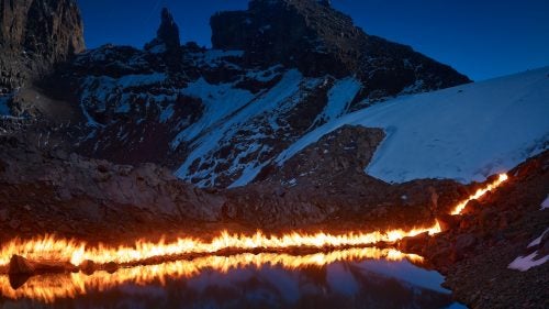 In 1947, the year marked by this fire line, the water was 50 feet higher and the back of the pond was a small cliff of ice. Lewis Glacier is one of the most surveyed tropical glaciers in the world and scientists have been studying it closely for decades. The abundance of information made it a perfect subject for Norfolk and this project.
