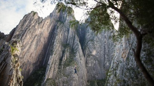 For six weeks last winter, I traveled with my friend Peter Hudnut and photographer Justin Lewis through Mexico’s Sierra Madre Oriental Mountains, a canopy of tropical and montane forests that stretches nearly one thousand miles from Monterrey to Veracruz. The mountains of Mexico are the home of the Tarahumara Indians and the site of Alex Honnold’s epic 2014 free solo on El Sendero Luminoso. But our plan was to establish highlines. We loaded enough bolts and webbing for eight new lines into the Volkswagen, and headed south across the border.
Photo: Potrero Chico—Spanish for “little corral”—is a collection of massive limestone spires that gates the northern entrance to the Eastern Sierra Madres. Peter walked this 220-foot long highline on Christmas Day, aptly naming it Feliz Navi Highline.