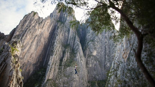 For six weeks last winter, I traveled with my friend Peter Hudnut and photographer Justin Lewis through Mexico’s Sierra Madre Oriental Mountains, a canopy of tropical and montane forests that stretches nearly one thousand miles from Monterrey to Veracruz. The mountains of Mexico are the home of the Tarahumara Indians and the site of Alex Honnold’s epic 2014 free solo on El Sendero Luminoso. But our plan was to establish highlines. We loaded enough bolts and webbing for eight new lines into the Volkswagen, and headed south across the border.
Photo: Potrero Chico—Spanish for “little corral”—is a collection of massive limestone spires that gates the northern entrance to the Eastern Sierra Madres. Peter walked this 220-foot long highline on Christmas Day, aptly naming it Feliz Navi Highline.
