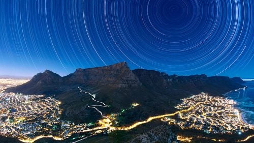 The World at Night’s annual International Earth and Sky photo contest was started in 2009 to promote the night sky as a natural wonder in need of protection. In conjunction with the volunteer and conservation efforts of the U.S. nonprofit Astronomers Without Borders and the National Optical Astronomy Observatory, the contest brings together nature photographers from around the world to give us a clearer look at what the sky should look like–without any light pollution. The result? A collection of photographs that capture the stuff of stargazers’ dreams.
Photographers hailing from 54 countries submitted more than 1,000 images this year. They follow a simple criteria: Include both the the Earth and the sky and pay “special attention” to astronomical perspectives and celestial phenomena. Here a few of 2015’s winners.
Photo: Star Trails Above Table Mountain
UK traveling photographer Eric Nathan, who has photographed in 87 countries, was awarded first place in the Against the Lights category for this image. The cityscape lights of some of Cape Town’s 987,007 inhabitants are juxtaposed against the flat-topped Table Mountain and the star trails above it. It is comprised of a stack or compilation of over 900 thirty-second exposures, all captured in June 2014.