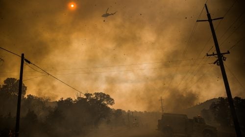 Firefighters attack the Rocky Fire in California from the air and ground on July 30.
