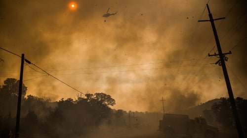 Firefighters attack the Rocky Fire in California from the air and ground on July 30.