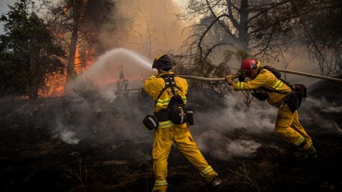Firefighters battle a spot fire on the Rocky Fire in Lake County, California, on July 30.