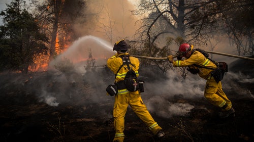 Firefighters battle a spot fire on the Rocky Fire in Lake County, California, on July 30.