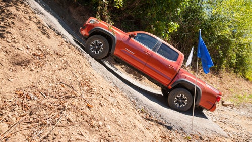 The outgoing Tacoma was plenty capable in the muck, and the new version is even easier to take off-road. We tested it on 40-degree slopes and a mini Toyota-built mountain and found that it handled this terrain with ease, thanks to a 29-degree approach/23-degree departure angle (translation: the truck’s nose and tail will not scrape when you want to climb something steep).
Toyota’s new Multi-Terrain Select and Crawl Control technology (available only on the six-speed automatic) also helps. Here’s how it works: Select the terrain you’ll be driving over (like sand or rock), and the truck regulates wheel spin and brake pressure according to the conditions. Finally, pick the Crawl Control Speed of 1-5 kph and just steer—no gas pedal or braking required.