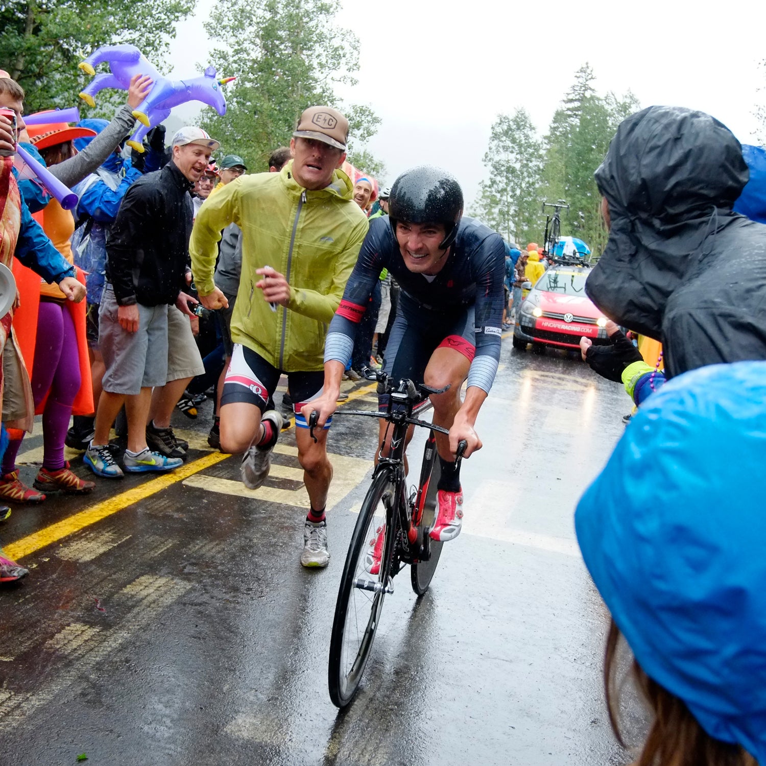 A fan joins USA's Joseph Rosskoph on foot in the last 200 meters of the USA Pro Challenge's Vail Time Trial, August 2014. The event has garnered impressive enthusiasm and crowds.