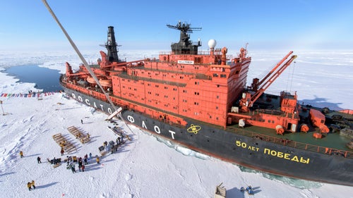 The North Pole! After five days at sea, 50 Years of Victory arrives at 90 degrees north on a crystal clear morning. There is no research base, historical marker, or any other indication that you’ve arrived anywhere special—other than your GPS. Once we found thick enough ice to disembark, the first order of business was to plant a big, red “North Pole” sign at the pole. Our outfitter Quark had brought along a hot-air balloon, allowing us to float above the pole. The tether can be seen just to the left in the photograph.