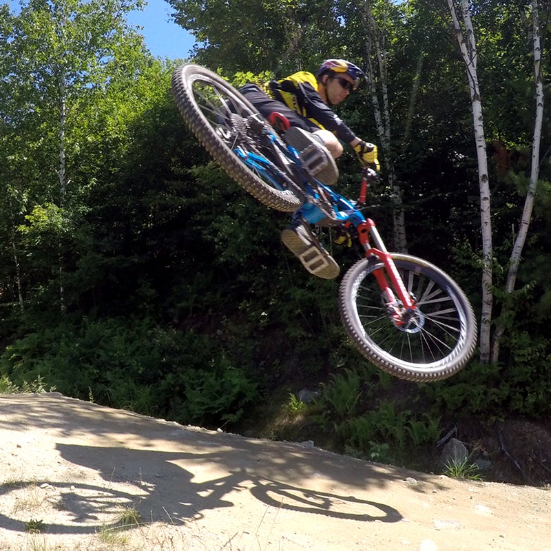 A whip is where you get your bike sideways in the air. First, find a jump you feel comfortable with. Second, think about the approach. You’ll want to be almost at the apex of your turn when you reach the lip of the jump in order to get sideways in the air. Finally, once you’re airborne, toss your bike and hips sideways, keep your head pointing straight down the ramp. @aaronchase