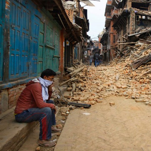 A Nepalese man sits near the debris after the earthquake in Bhaktapur near Kathmandu, Nepal on April 26.