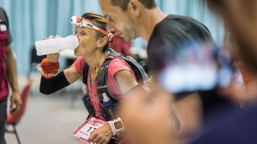 Nathalie Mauclair, who won the women’s race, hydrates during a quick pit stop.