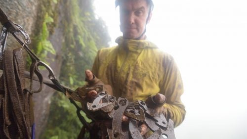 Libecki showing off the gear that keeps them safe—muddy “bird beaks,” which he hammers into small cracks and crevices on lead.
