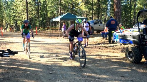 Juliana brand manager Katie Zaffke (right) sprints across the finish line of the first timed segment, a brutal one-mile pitch of the 17-mile climb.