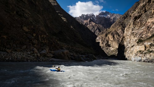 Hey all you paddlers and water junkies: Imagine a river with steep, big water rapids like the Stikine in British Columbia running through deep-walled canyons like the Grand Canyon in Arizona. It’s understandably hard to visualize, but these pictures of Kyrgyzstan’s Sary-Jaz River should help. The river begins at the Inichelk Glacier—one of the largest non-polar icecaps—and descends through inescapable rapids and steep canyons that narrow to nearly one meter across in the tightest sections. That’s a description to send most people running. For others, like photographer and paddler Erik Boomer plus a team of proven international kayakers, it sounds like an invitation. Here, Boomer shares a few of his favorite images from the crew’s September expedition down one of Asia’s most difficult rivers.
Photo: Days felt short in the canyon as the sun would quickly pass and jump from one wall to the other. Here, paddler Jared Meehan flows into the shade.
