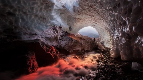 The June expedition was Josh Hydeman’s sixth visit to the Sandy Glacier caves, but the 34-year-old cave photographer said the experience–and the state of the caves–is always different. “Every time I visit the caves there are different things that interest me–a frozen column or a new skylight,” he said. On this trip, he managed to capture where the glow of sunset entering the cave, making the stream appear red. “I’ve never seen anything like that.”