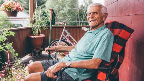 Lahout on the porch above the store, where he sits to relax, read, or ride the stationary bike in the background.
