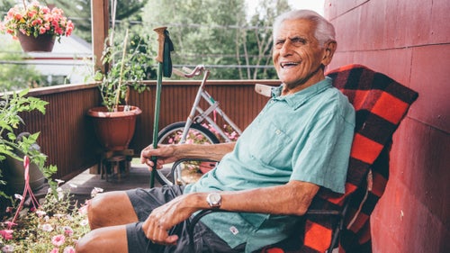 Lahout on the porch above the store, where he sits to relax, read, or ride the stationary bike in the background.
