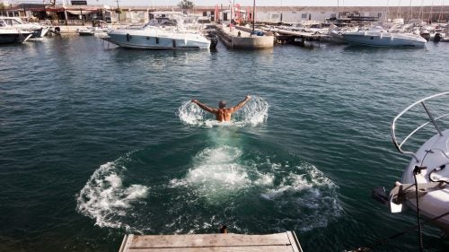 Back from the calanques, Franc stretches with a last swim in the harbour.