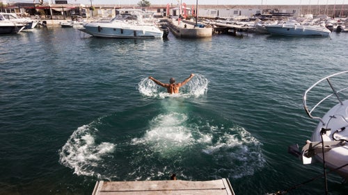 Back from the calanques, Franc stretches with a last swim in the harbour.