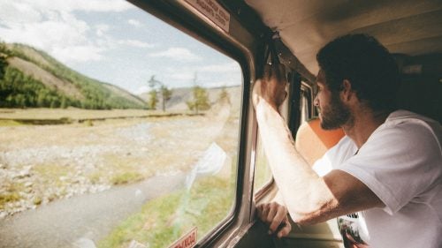 After barely 20 miles of paved road, our stoic driver, Olga, took a random turn off the asphalt and down jarring dirt tracks toward the horizon. The scenery alternated from dense coniferous forests to vast valleys to key-lime hills to dried-up riverbeds. That handle I’m hanging onto in the van ripped off within four hours.