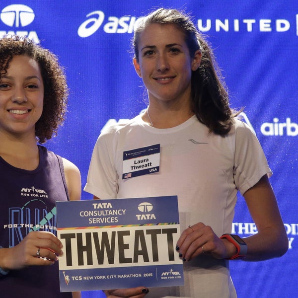 Run for the Future participant Carolyn Navarro, left, presents Laura Thweatt her New York City Marathon bib on October 30.