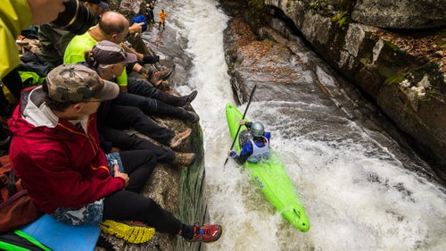 In the whitewater mecca of Asheville, North Carolina, the first Saturday of November belongs to the Green River Narrows Race. First established 20 years ago by a group of 16 hard-charging locals, the race has grown into one of the country’s most competitive and respected, with the biggest names in the sport returning year after year to battle it out. There’s no money on the line and no barrier to entry. But it’s been called the Super Bowl of Kayaking for good reason, packing a raucous audience atop the tight canyon walls of what locals call the bedrock coliseum. As photographer John Webster discovered, it’s also a damn good time. Photo: The three-quarter-mile-long course is notoriously brutal, taking paddlers through a chain of powerful class V rapids punctuated by a narrow 18-foot drop dubbed Gorilla. But it’s what happens out of the water that sets the Green race apart: whereas most backcountry whitewater competitions only draw a handful of spectators, the Green packs the crowd ten-deep, with spectators just feet from the the river, their cheers and hollers blasting off the tight canyon walls.