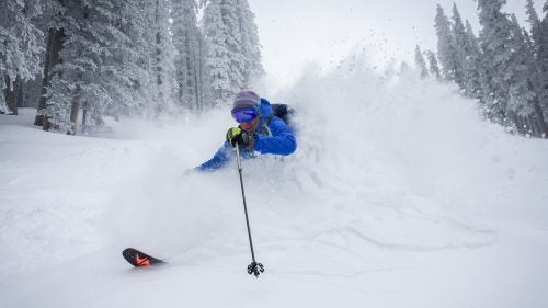 Outside contributing editor Nick Heil gets buried in deep snow near the top of Ski Santa Fe. I told Heil to ski fast and come right at me so we could get a sense for how deep the snow really was.