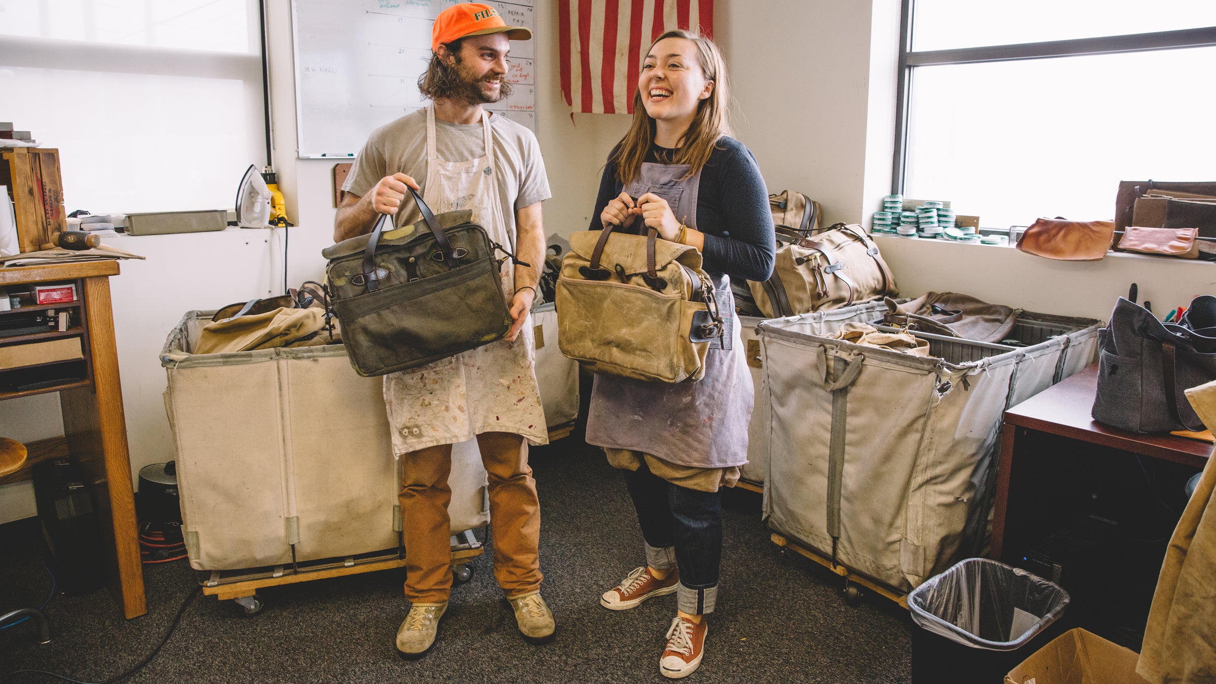 Evan Franz and Claire Beaumont holding some restored bags in Seattle this November.