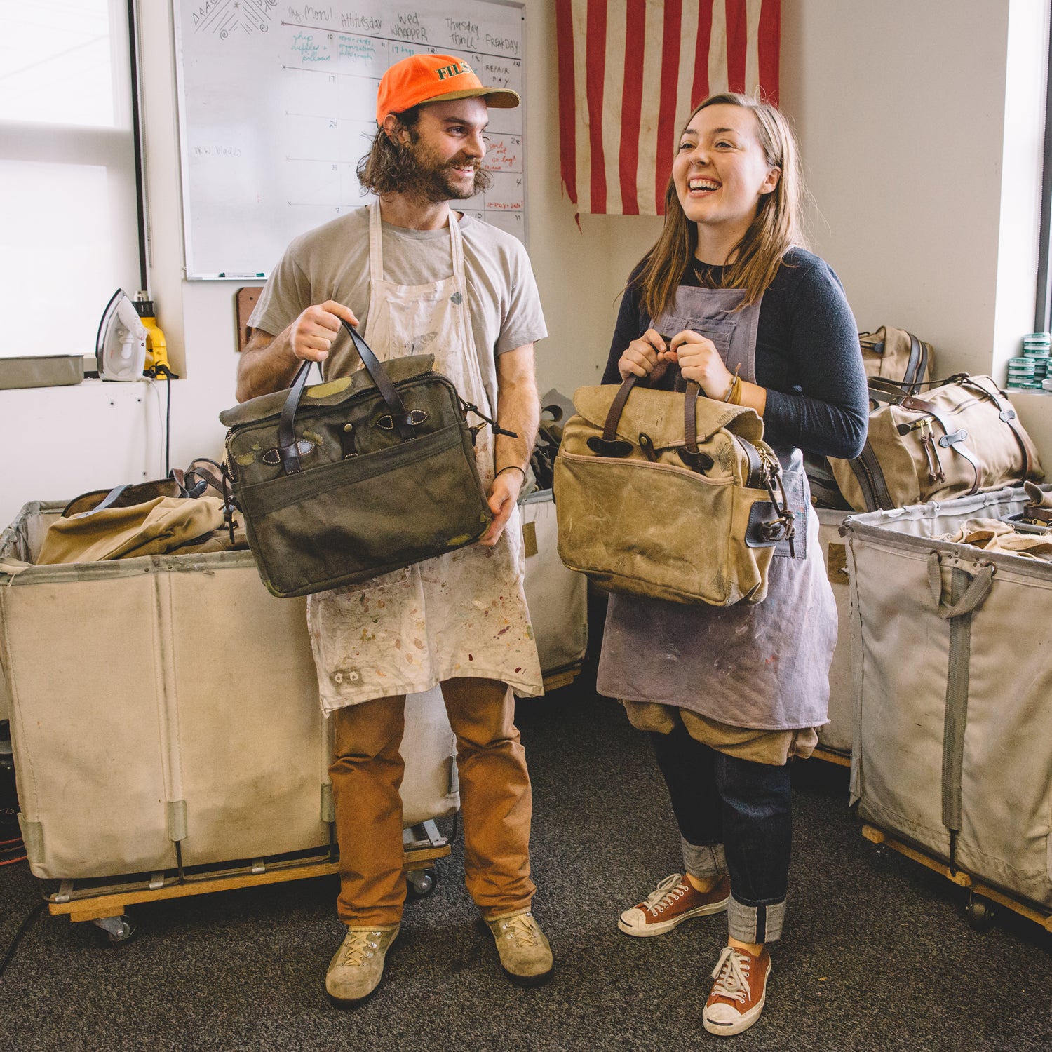 Evan Franz and Claire Beaumont holding some restored bags in Seattle this November.