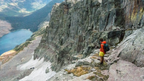 Mike Foote gazes down at Sunburst Lake, nestled in the craggy Swan Mountains. The Mikes had to down-climb a fifth-class face, and then stem between a glacier and its bergschrund to get through this section. “We were definitely at our limit at times,” Foote says. “But that's why we did it.”