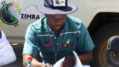 On Day 2, we crossed the Shashe River into Zimbabwe, where immigration officials sorted through our passports, dutifully writing down the serial numbers of each bill we used to pay for our entry visas. The customs officer was particularly friendly and happy to pose for photos. The logo on his shirt reads, “I am not corrupt.”